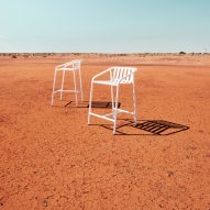 White stools on orange earth in outback