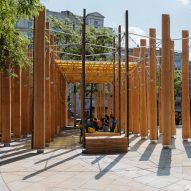 Wooden seats for pedestrians amidst timber installation