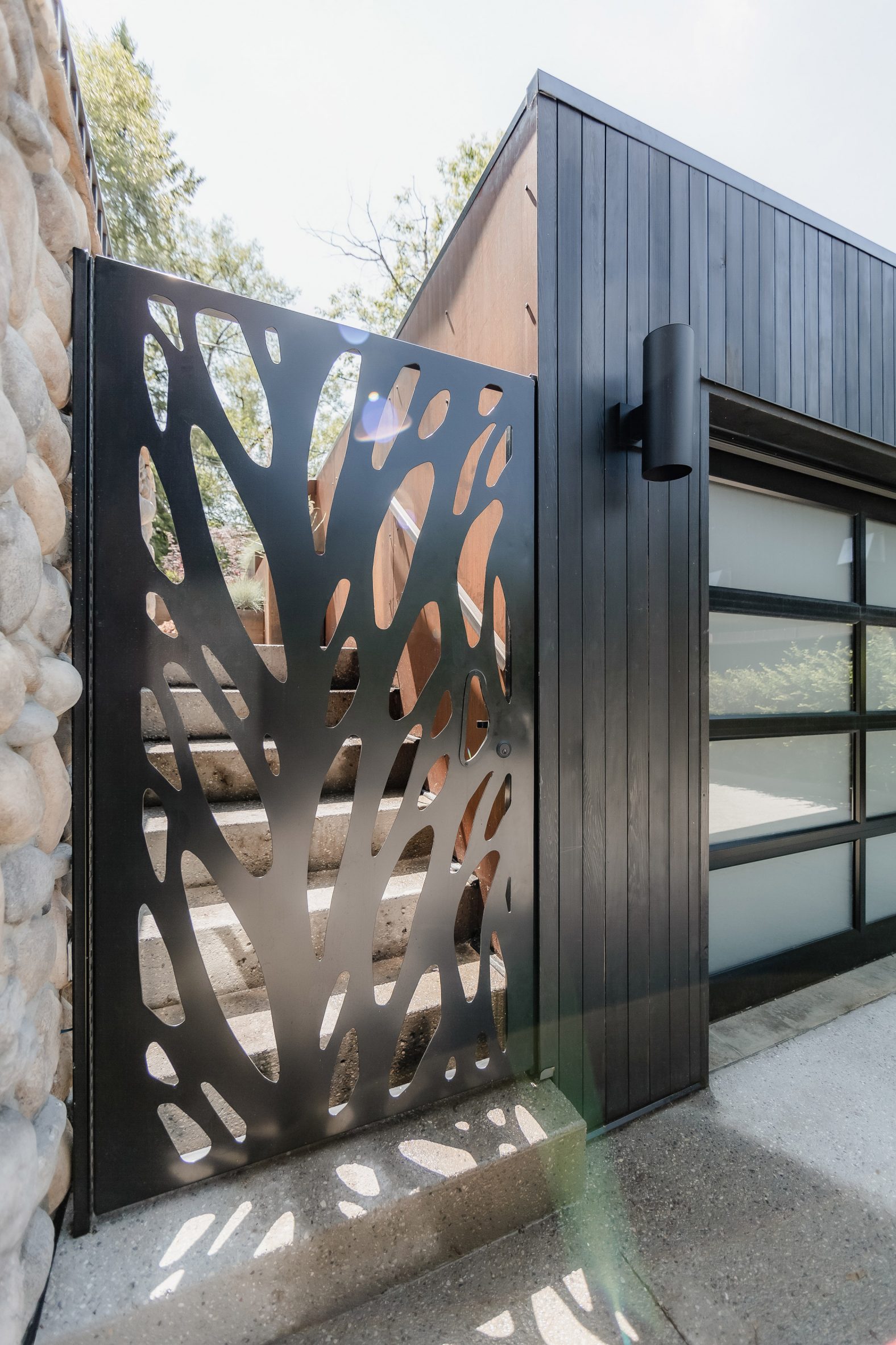 Steel gate with vine-like perforations