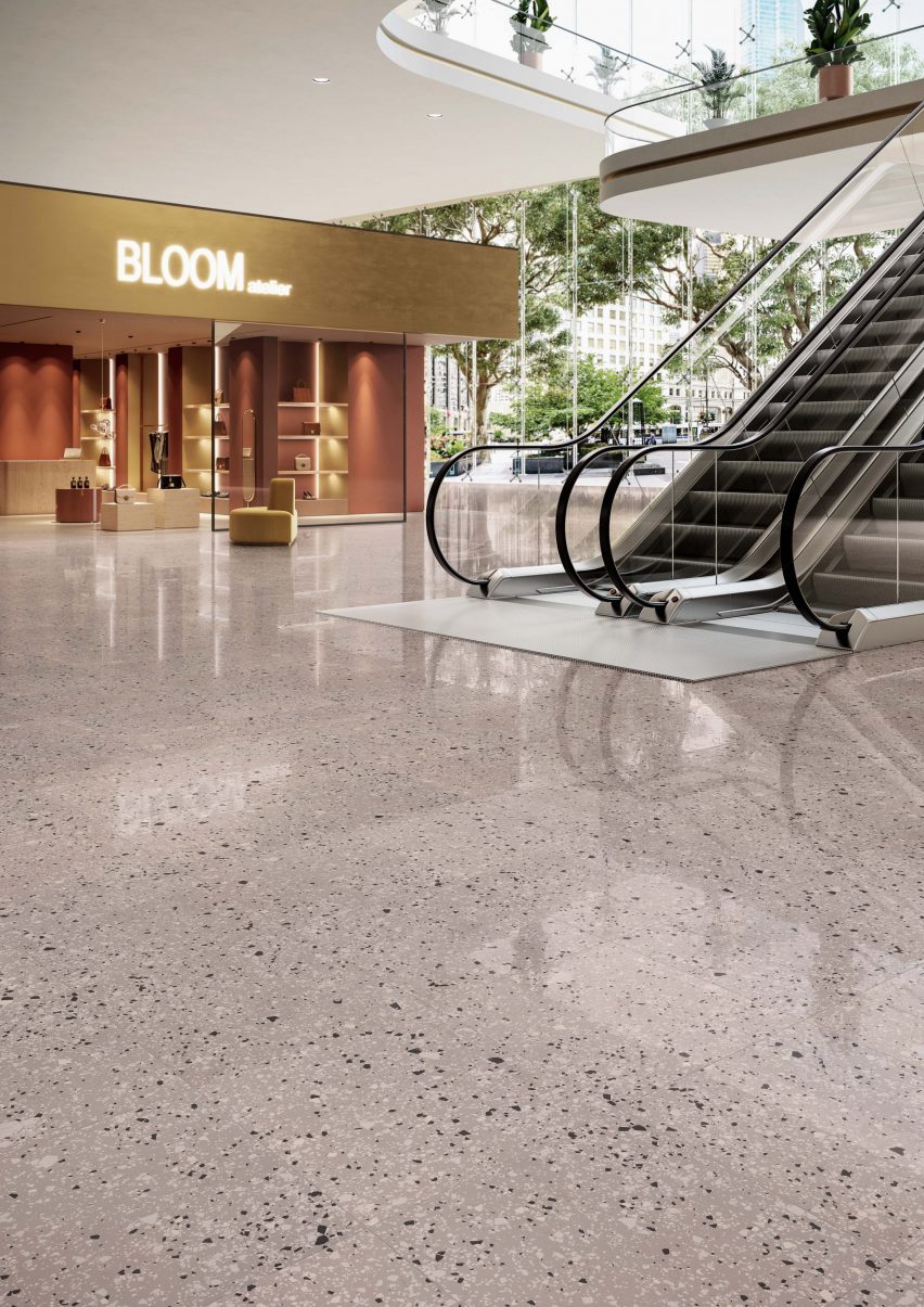 Shopping centre escalator area with shiny terrazzo-style floor