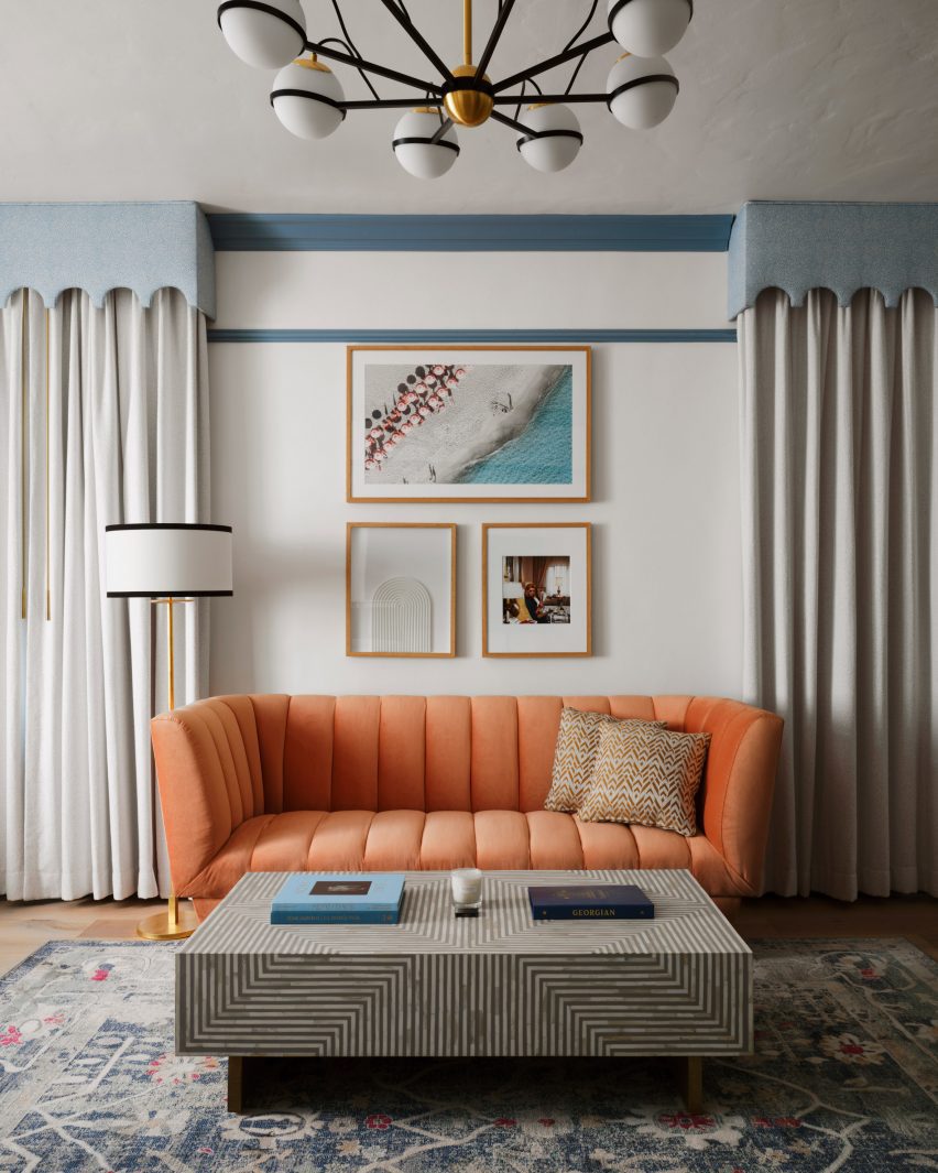 Peach-colored sofa between tall curtains