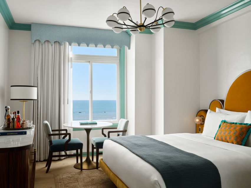 Guest room with art deco-influenced furniture and an ocean view
