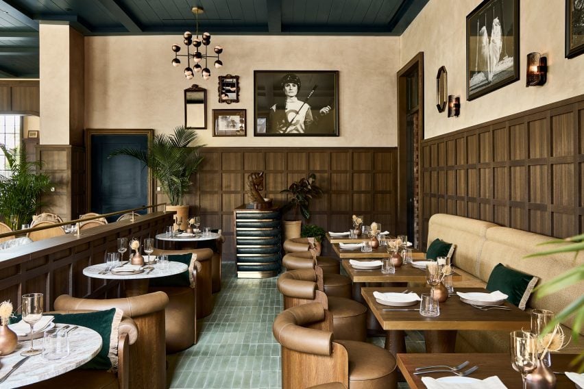 Restaurant with walnut wainscoting, green floor tiles and taupe furniture