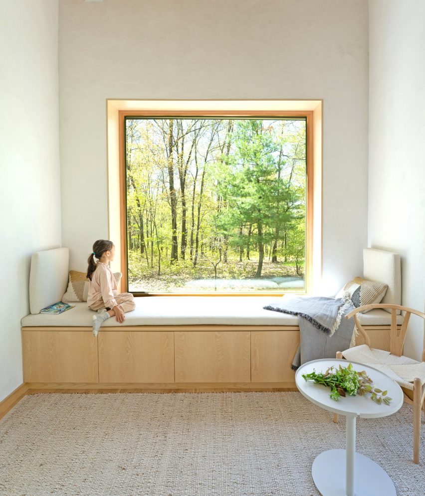 A window bench with light wood and a large picture window