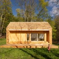 A small cabin with large sliding glass doors and cedar shingles