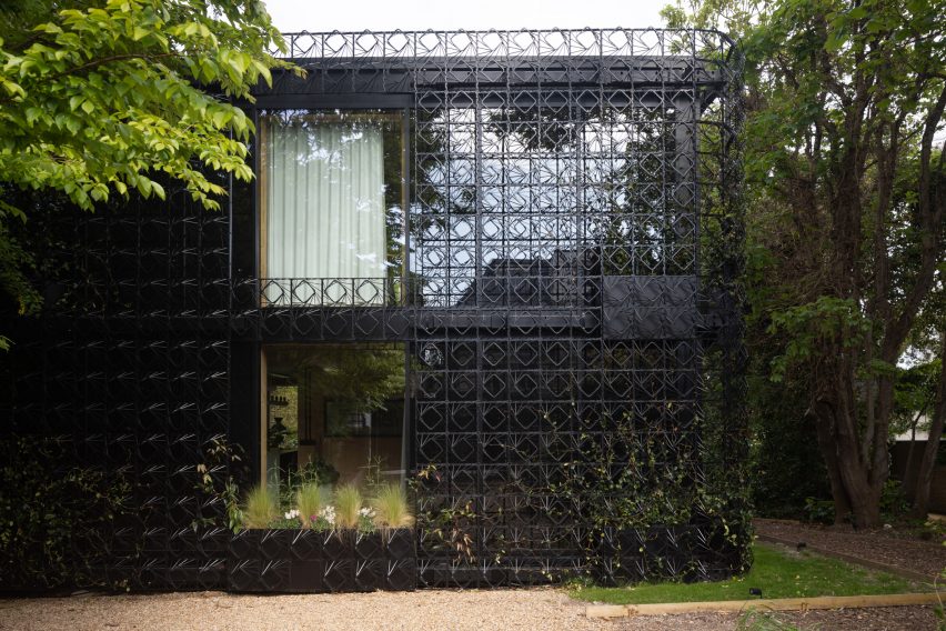 Home wrapped in metal plant screen
