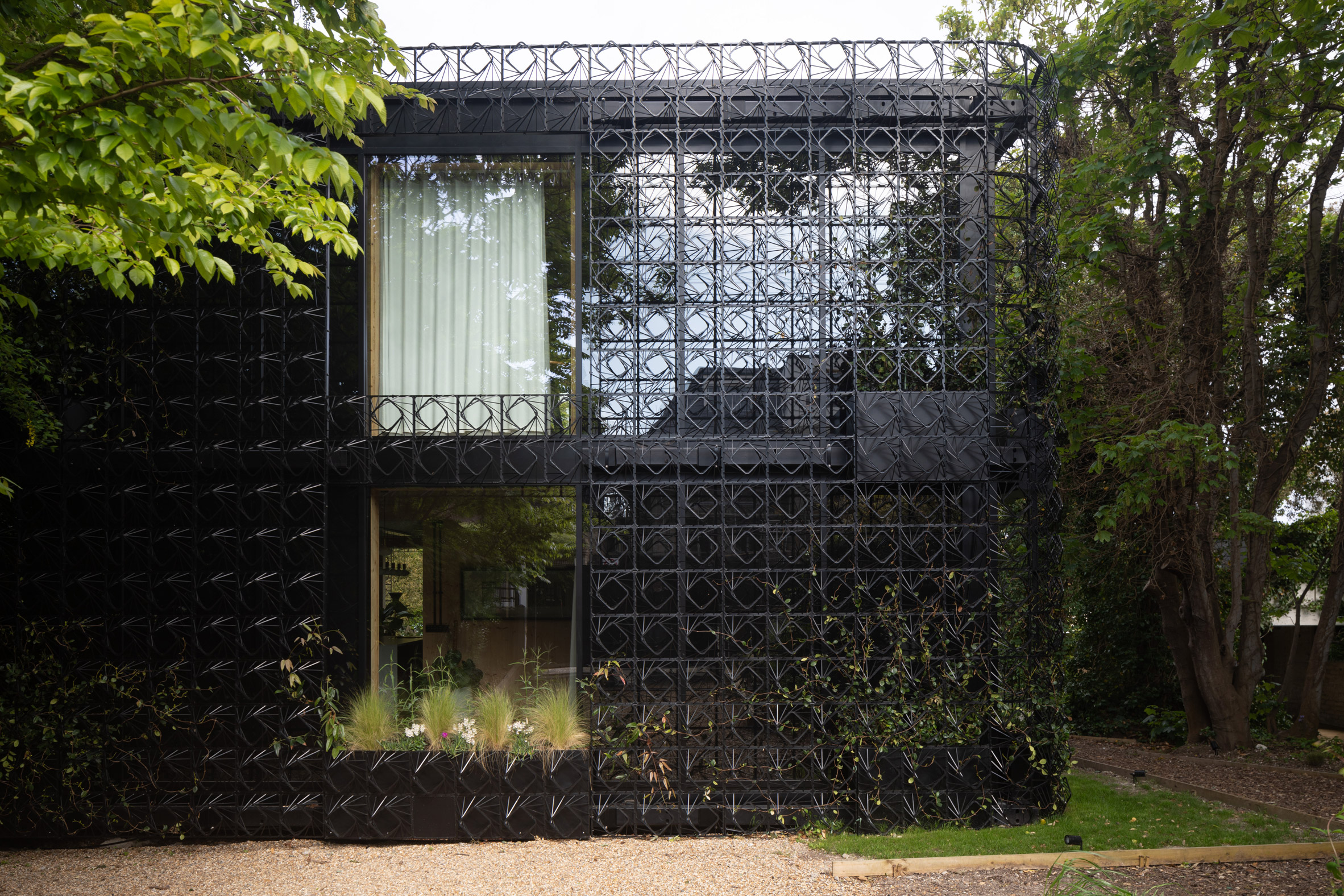 Home wrapped in metal plant screen