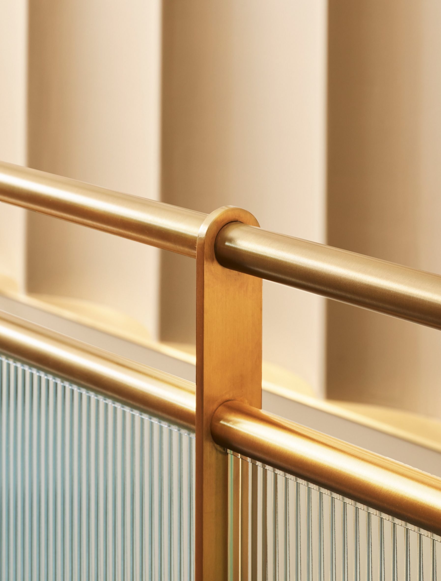 Detail of brass railing with fritted glass partitions