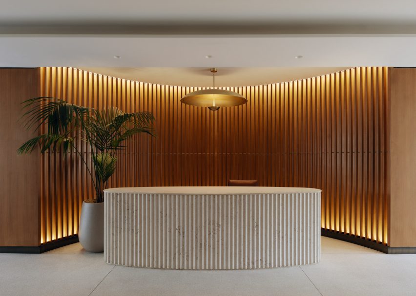 Oval reception desk made of fluted stone