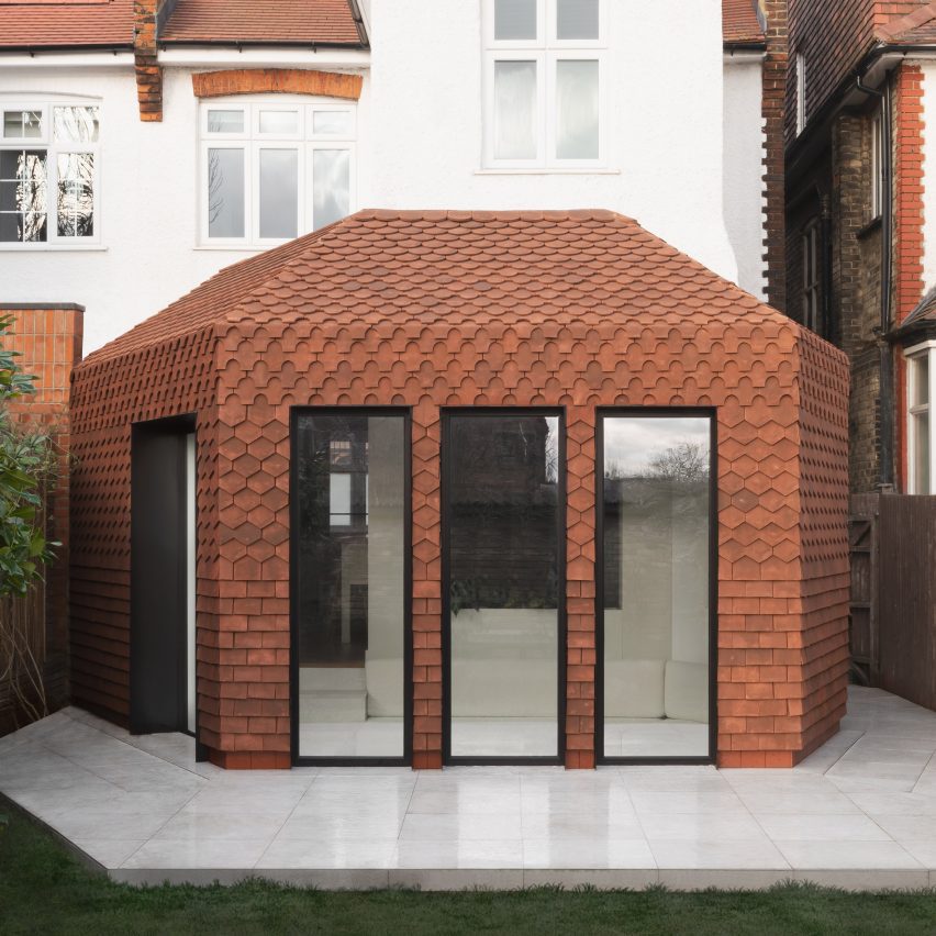 An extension clad in red clay tiles