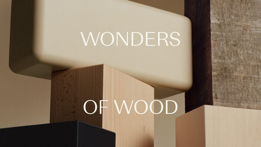 Logo of Wonders of Wood against a photo of wooden blocks
