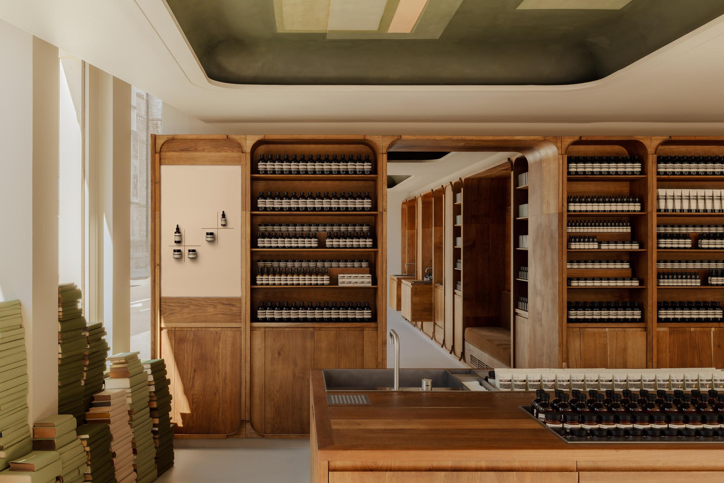 Piles of green-hued books characterise London Aesop store