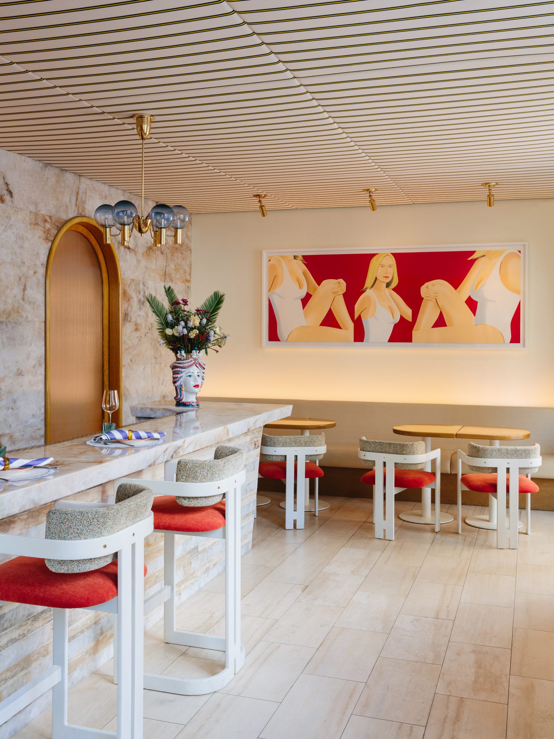 Bar area with striped fabric ceiling and Alex Katz painting