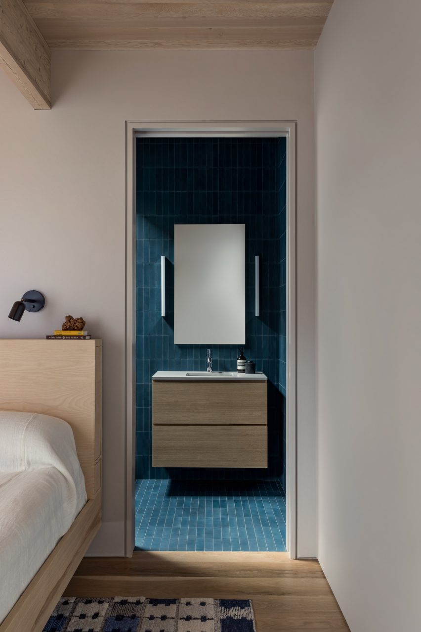 View from bedroom into a blue-tiled bathroom