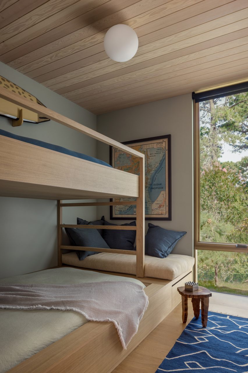Wooden bunk bed with view through full-height window