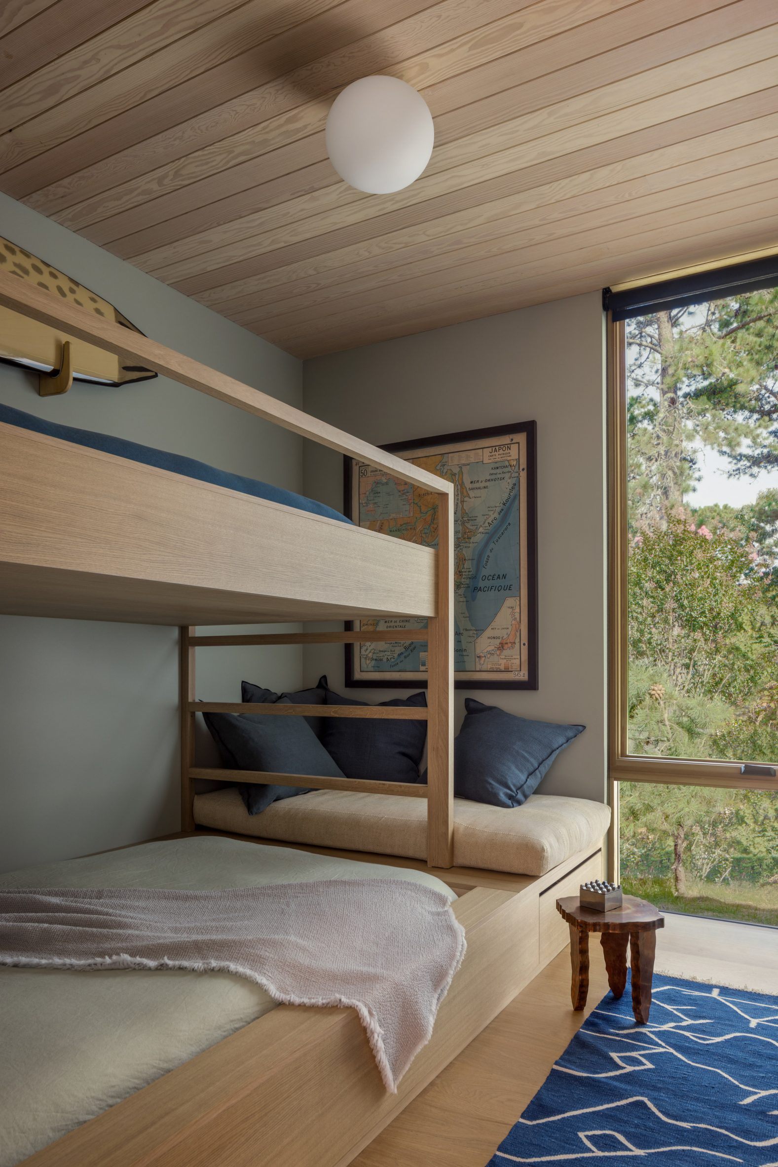 Wooden bunk bed with view through full-height window