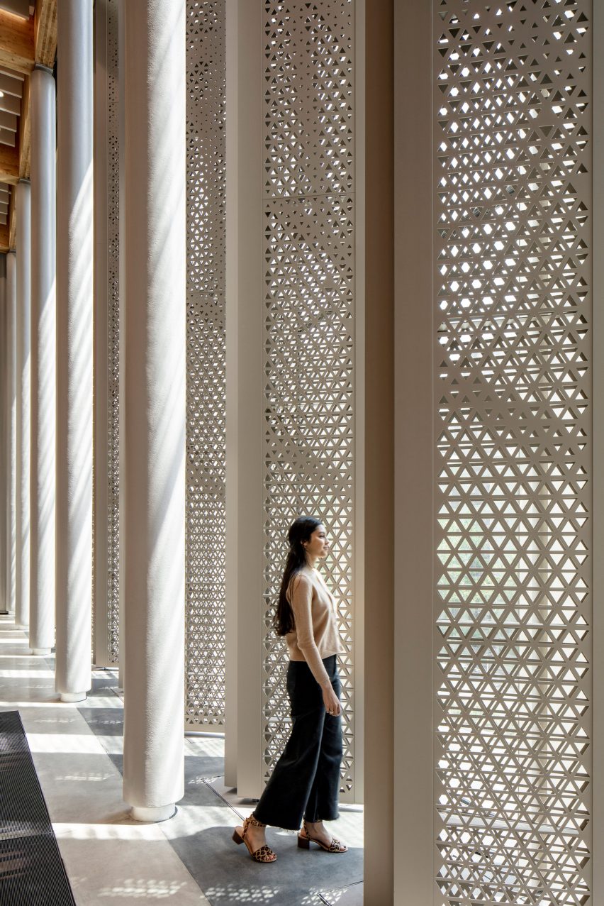 A woman standing in front of louvres