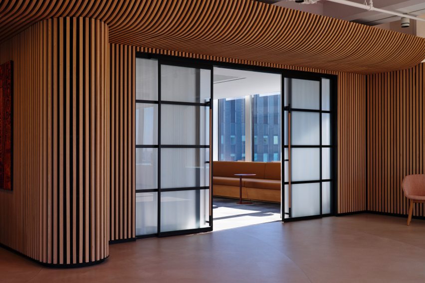 Frosted-glass sliding doors surrounded by vertical oak battens