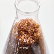 A beaker with small brown pelletes