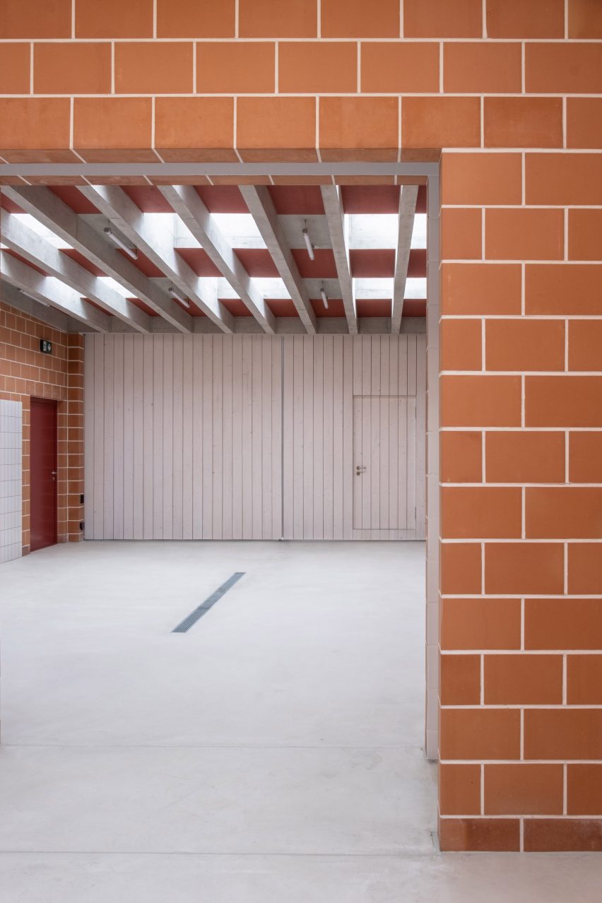 Gardeners workshop interior with concrete floors and roof beams and terracotta brick walls