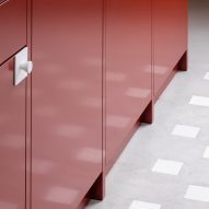 Red metal kitchen units on a concrete floor