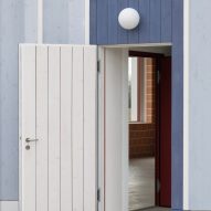 White open door on a blue timber building