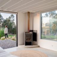 A woodstove in the corner of a living room with concrete floors