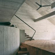 A concrete house with an angular interior and brick floors
