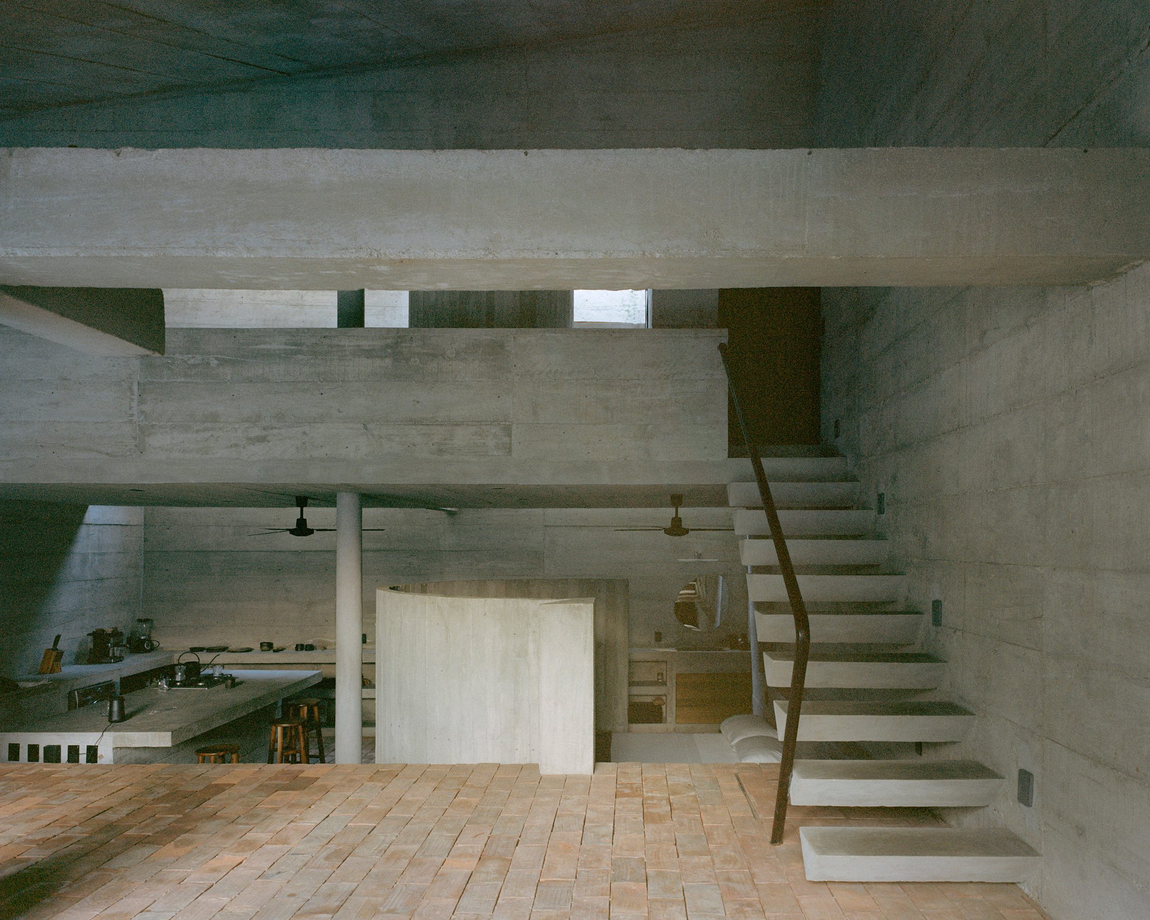 A concrete staircase that leads to a loft