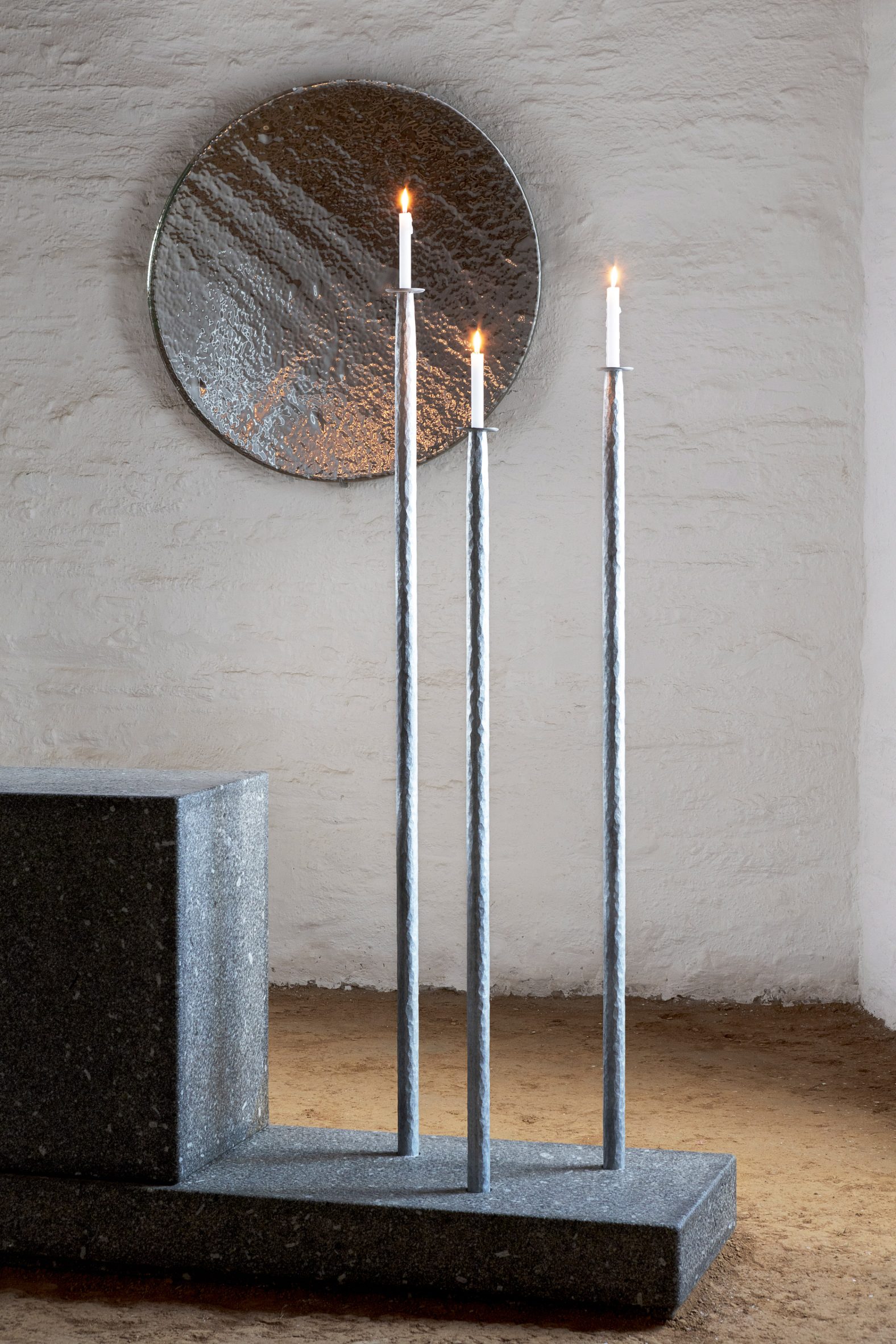 Steel candle holders inside chapel interior by Ronan Bouroullec