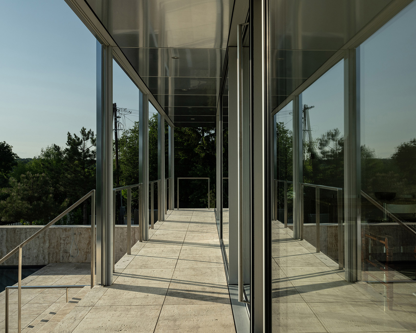 Walkway outside steel and glass pavilion in Hungary