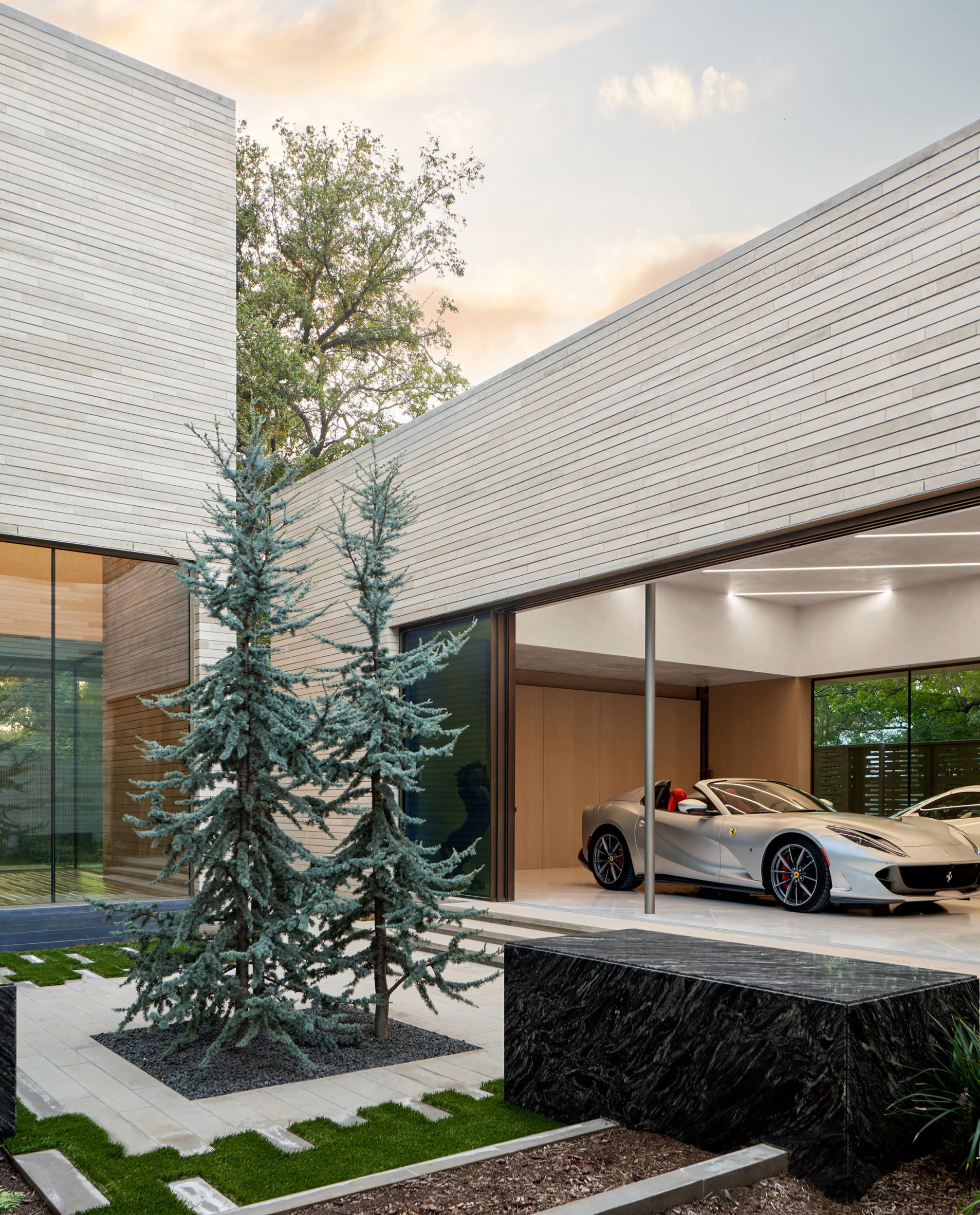 Limestone-clad dwelling with a Ferrari car in the background