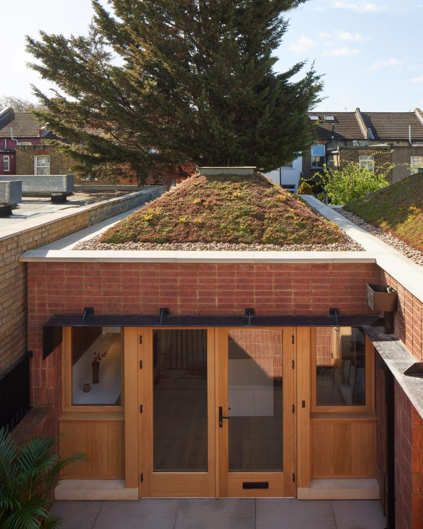 Pyramid shaped green roof and front door of Haringey Brick Bungalow