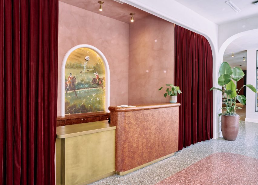 Lobby with pink terrazzo floor and matching plaster walls