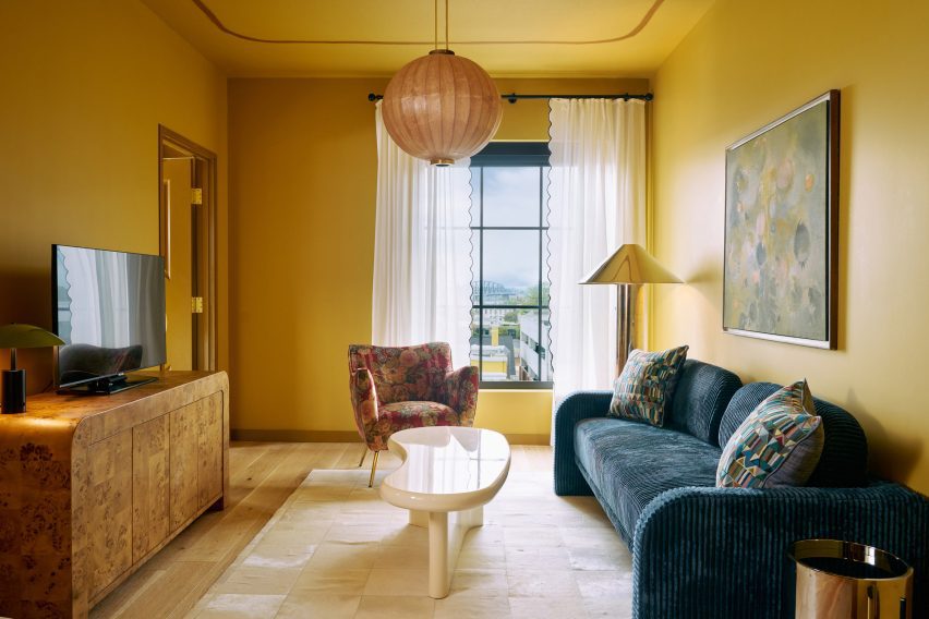 Yellow-coloured living room within a hotel room