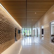 Indoor circulation space with a perforated brick wall