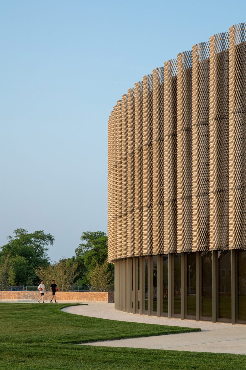 Exterior of a curved building with perforated aluminium cladding