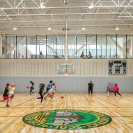 Indoor basketball court with exposed brick walls