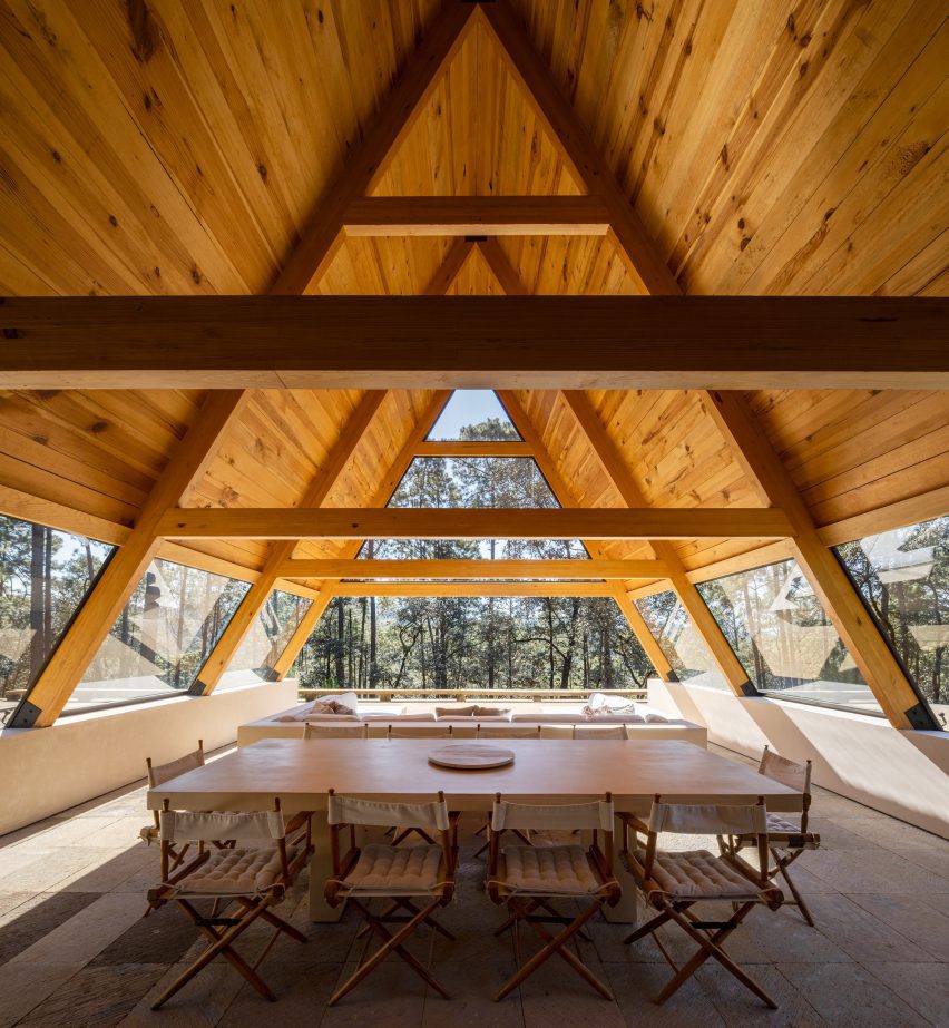 A large dining table underneath an A-frame structure