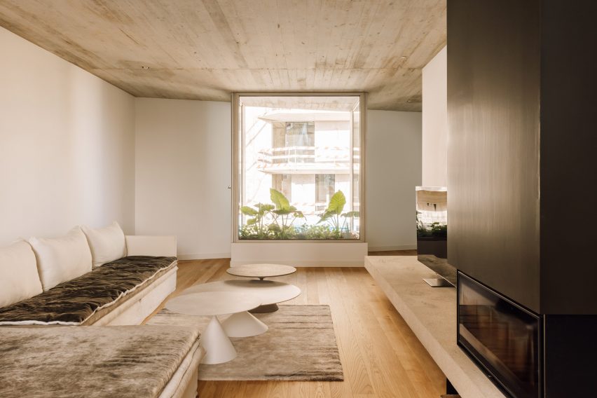 Living room with wood flooring, exposed concrete ceiling and flower window box