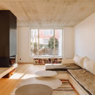 Living room with wood flooring, white walls, concrete ceiling and white sofa