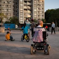 Man in wheelchair and kids playing