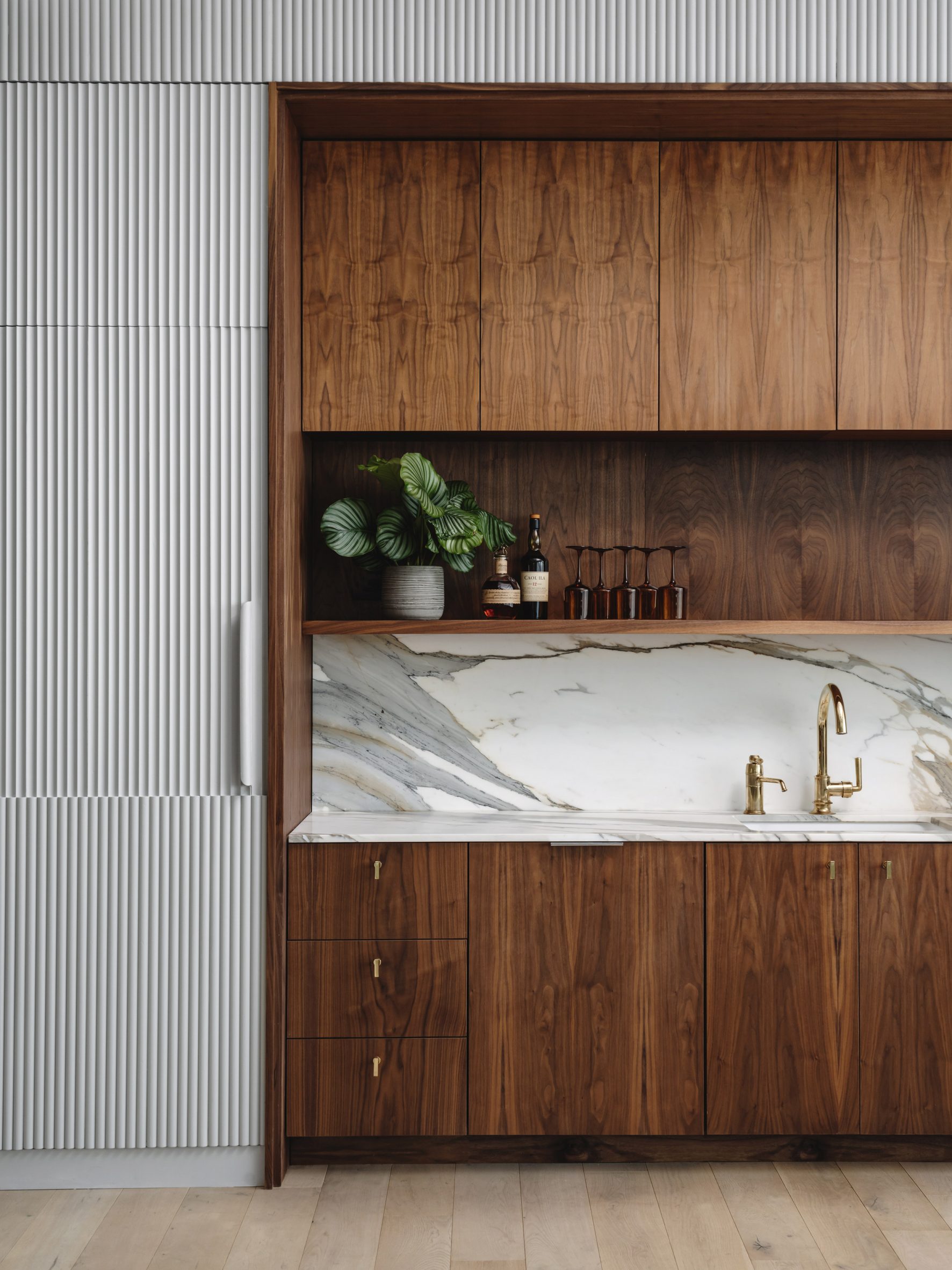 Wooden cabinetry and grey pannelling