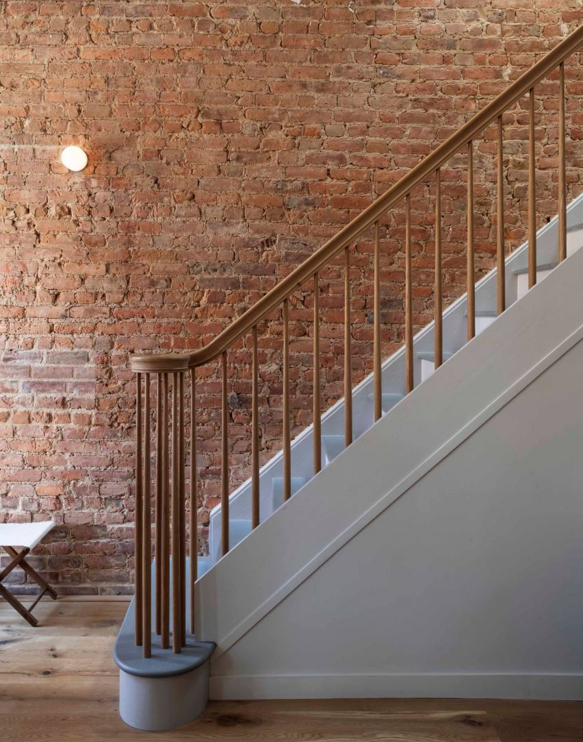 Brick wall and staircase within Brooklyn townhouse by TBo