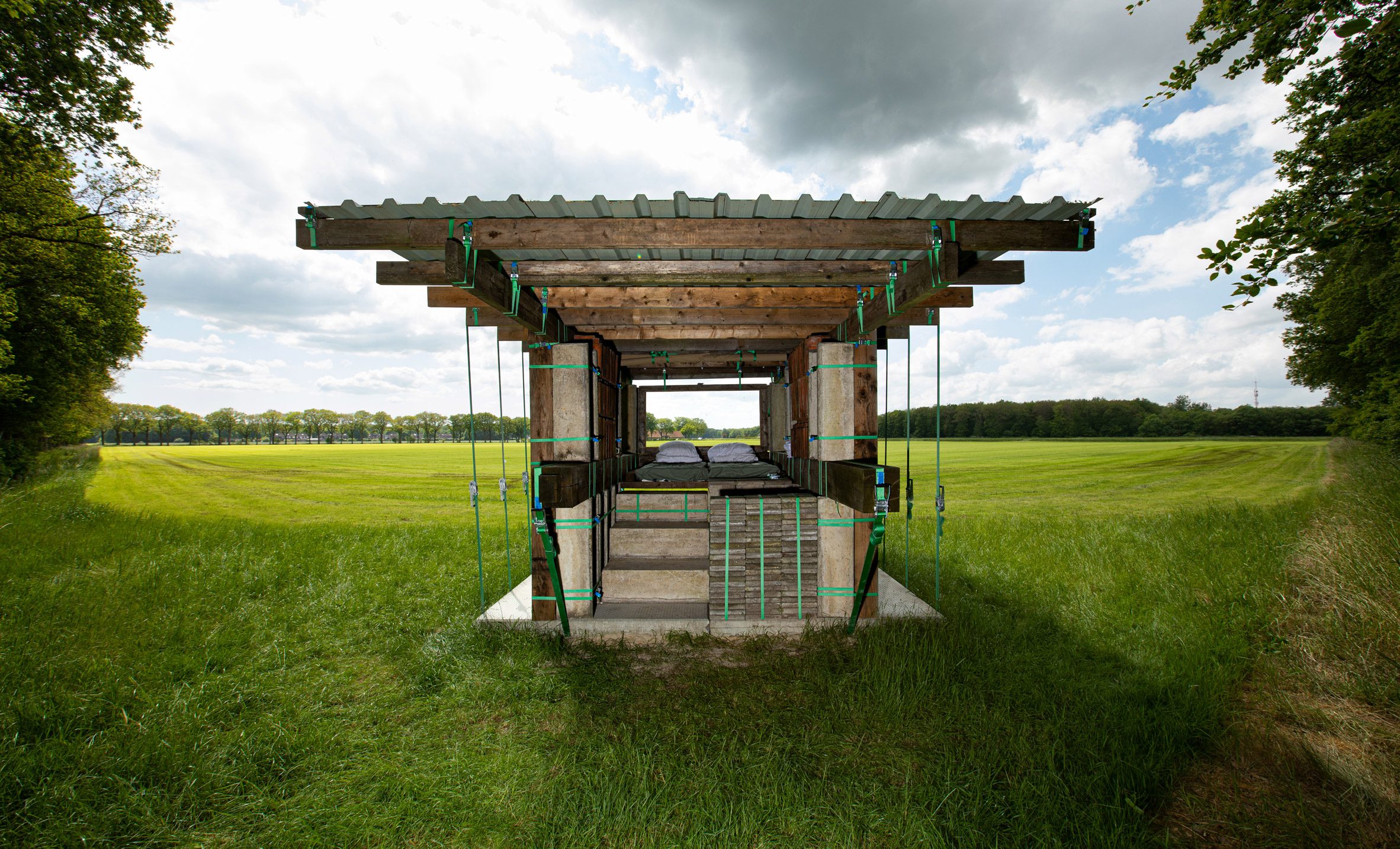 STABLE STACK is a temporary hotel room with a view of farmland, by Overtreders W