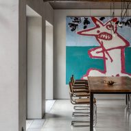 Photograph of dining room with art on back wall