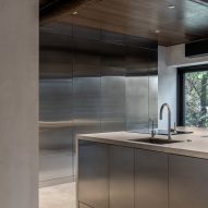 Photograph of concrete and stainless steel kitchen