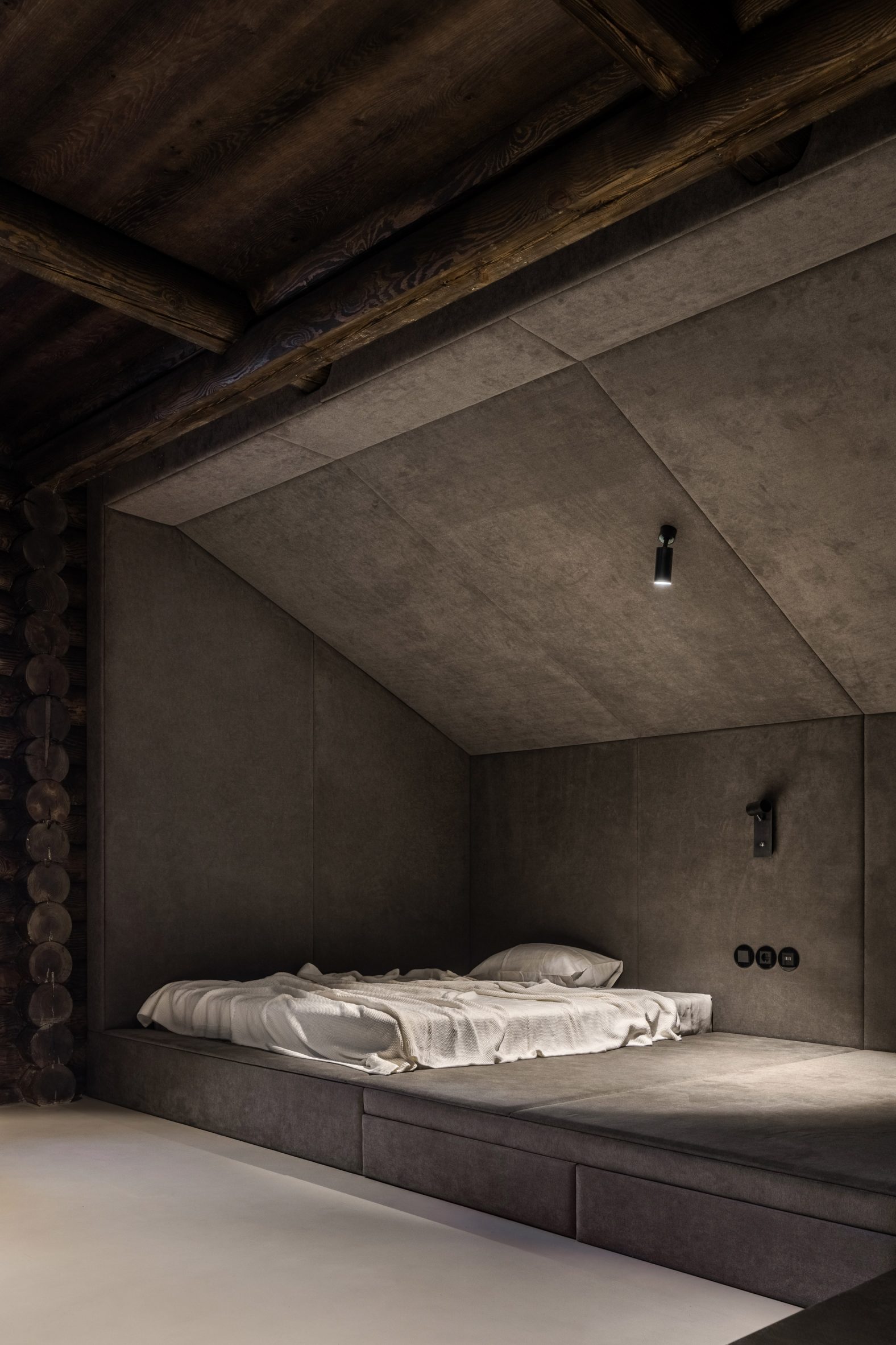 Padded dark bedroom in a log cabin