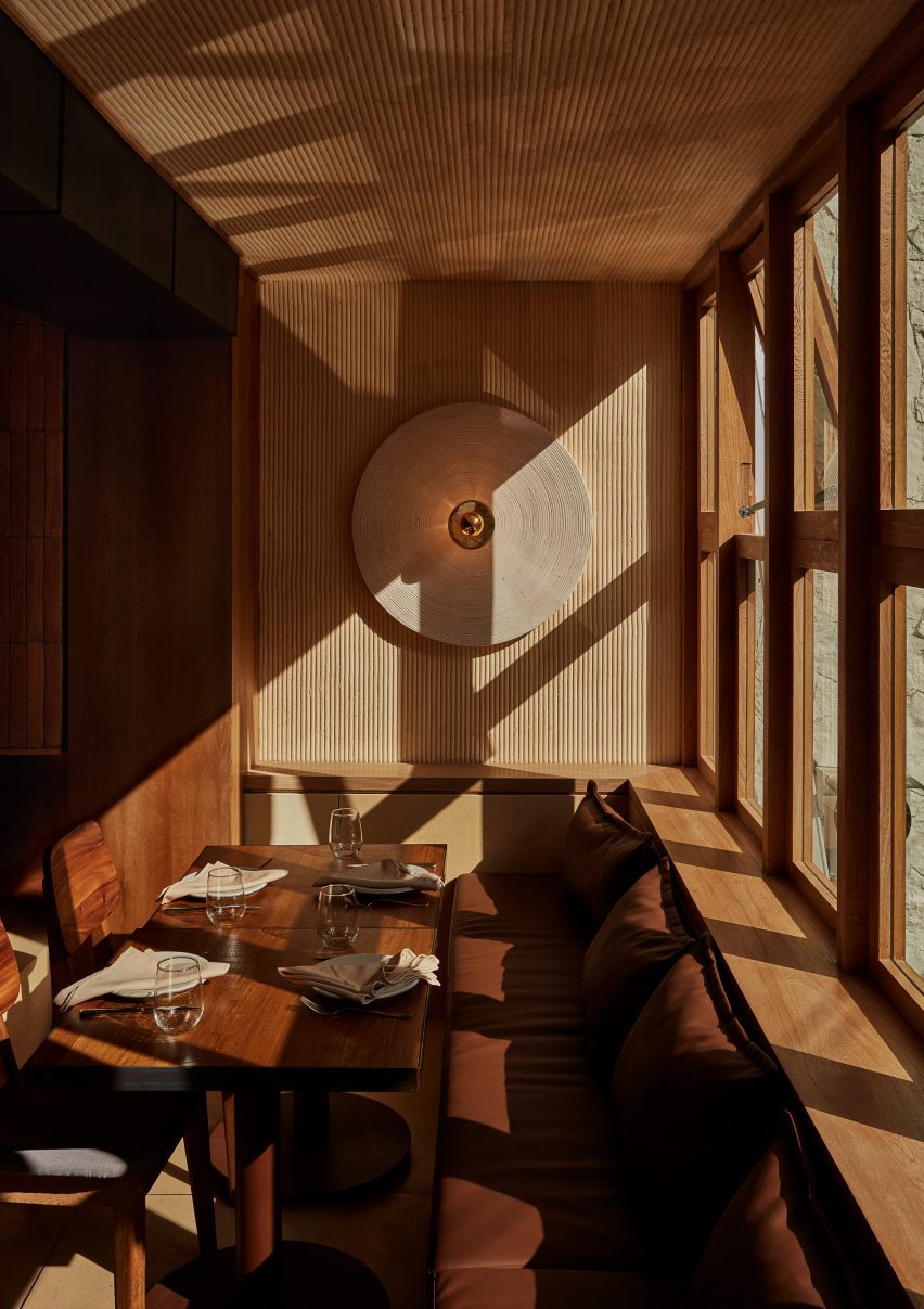 A corner table in a restaurant with wooden clad walls