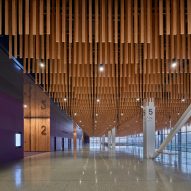 A textured ceiling made of suspended wooden planks